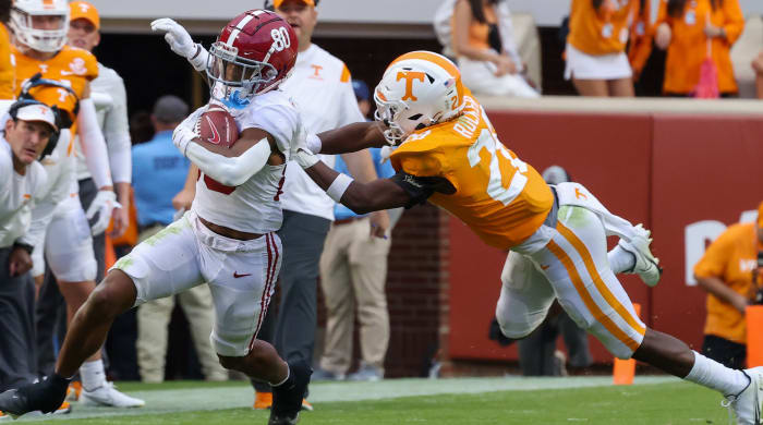 Tennessee defensive back De'Shawn Rucker tries to tackle Alabama Crimson Tide wide receiver Kobe Prentice
